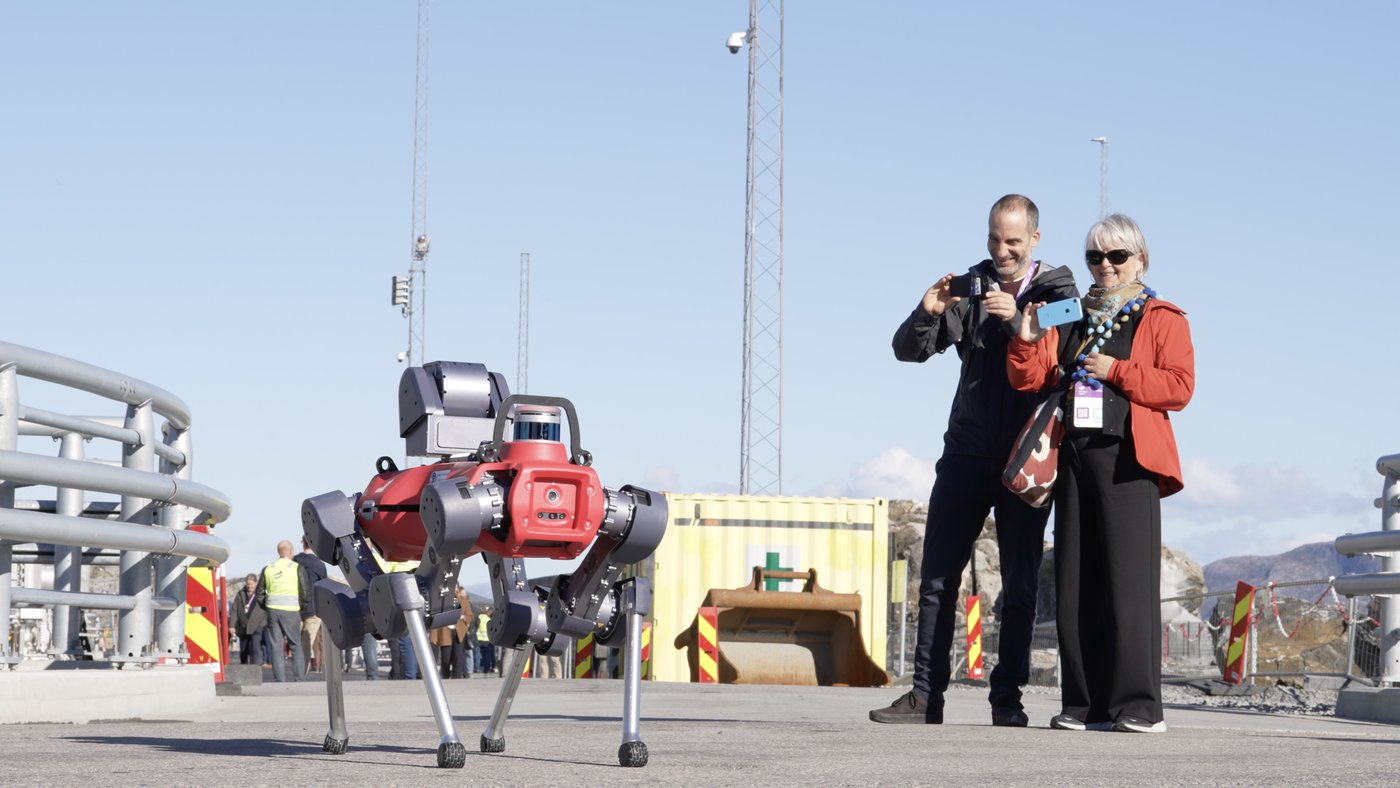 Locals photograph a robot during the Northern Lights site opening.