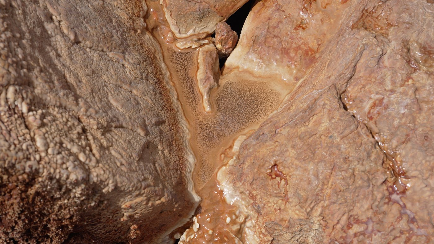 Carbonate accumulations on the rocks surrounding Crystal Geyser.
